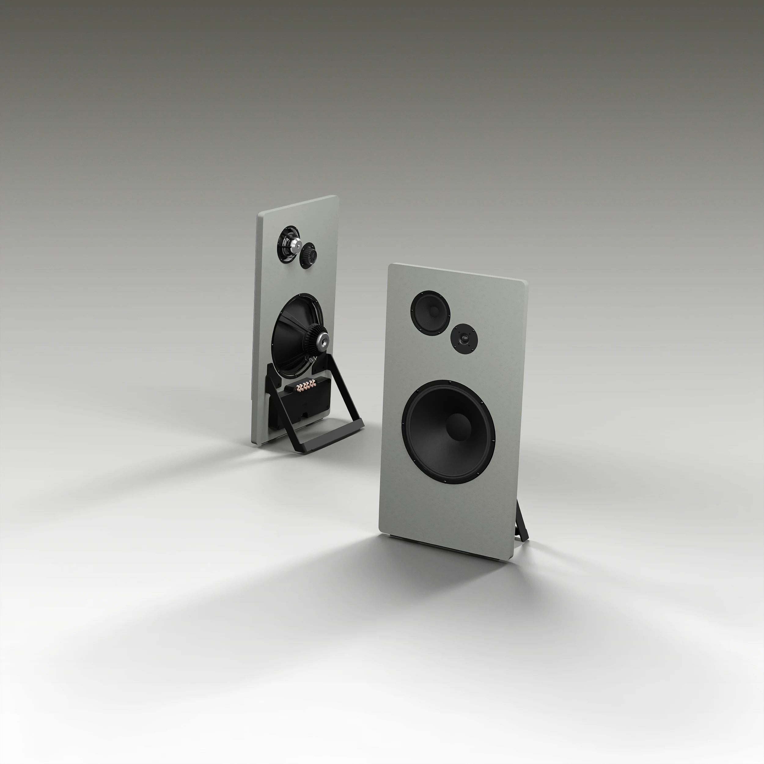 Pair of grey rectangular speakers with black drivers, one showing the front and the other the back with exposed components, on a white surface.
