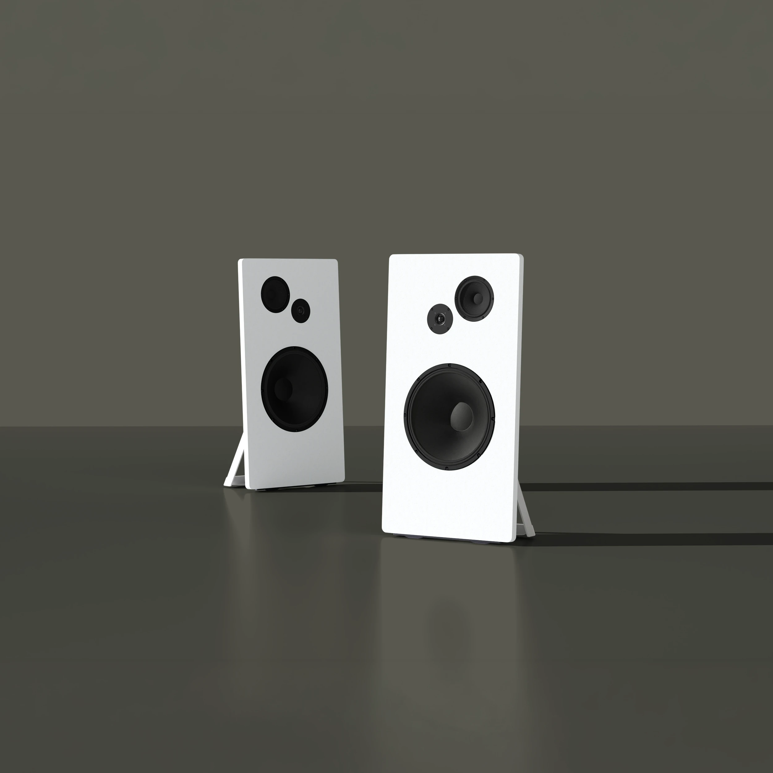 Two white modern speakers with black drivers standing on a reflective dark surface with shadows behind them.